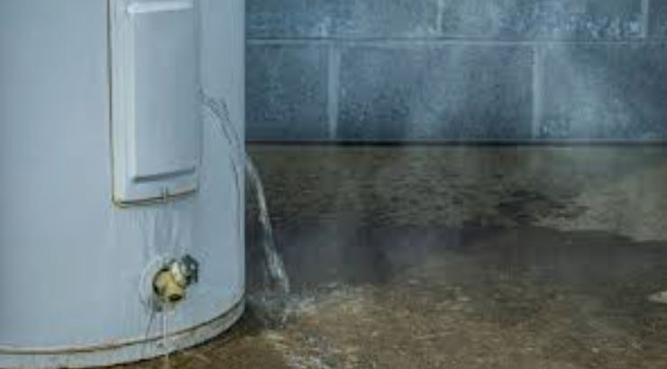 Leaking-hot-water-unit-with-water-on-ground.